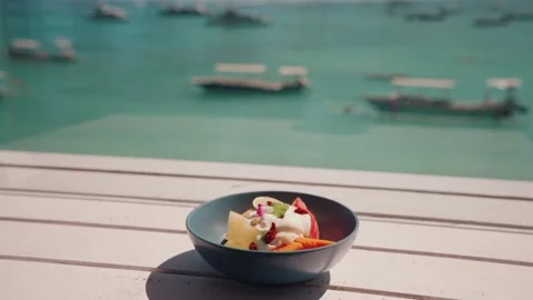 Tropical dining Bowl overlooking turquoise ocean boats coastal scenery Vídeo Stock 341508191