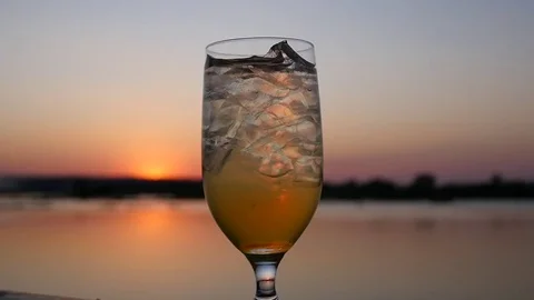 Tropical Drink in Front of Sunset Stock Footage 77765869