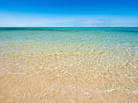 Tropical empty beach on a bright sunny day sea horizon in the background Stock Photos