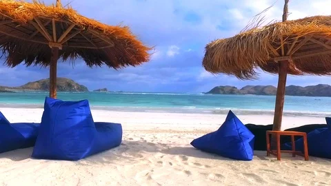 Tropical empty sandy beach with umbrella and beach chair Video stock 119617644