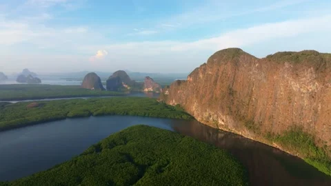 Tropical forest and river catch first sunlight near limestone hills, Thailand Stock-Footage 310166416