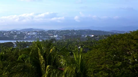 Tropical forest in front of a small town Vidéo 265186737