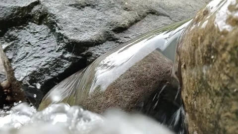 Tropical forest river flowing between natural rocks Stock Footage 329883576