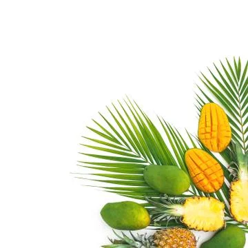 Tropical frame with pineapple, mango and palm leaves on white background. Fla Foto stock