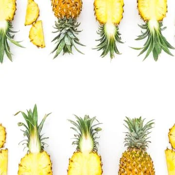 Tropical fruit frame. Sliced pineapple isolated on white background. Flat lay Stock Photos