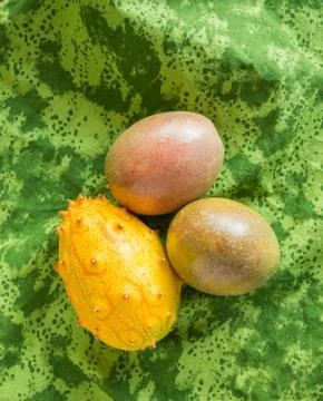 Tropical fruit isolated on a green patterned cloth Stock Photos