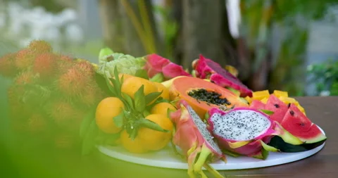 Tropical fruit platter dragon fruit, kiwi, pineapple, and assorted fresh Stock Footage 315314734