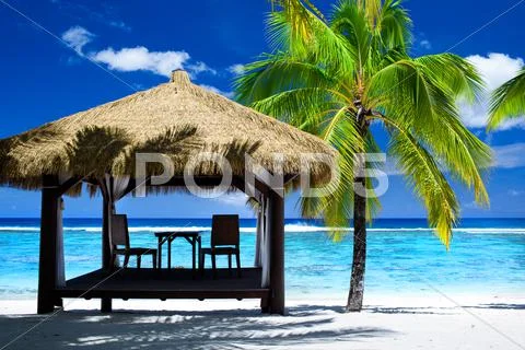 Tropical gazebo with chairs on amazing beach Stock Photos