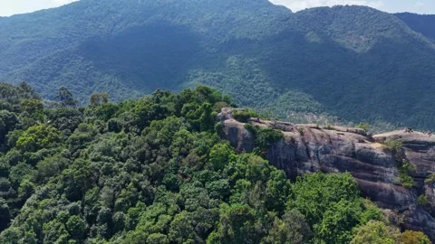 Tropical Granite Rock Formation Surrounded by Lush Hills 動画素材 331087183