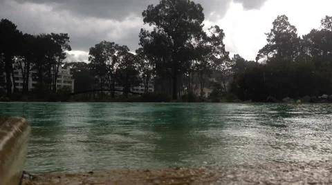 Tropical hard rain storm over lake / pool.  HD Stock Footage 48674855