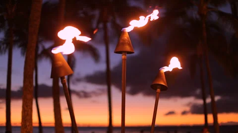 Tropical Hawaii fire torch tiki evening sunset palm trees sky Stock Footage
