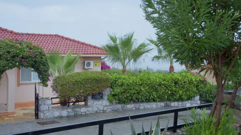Tropical House in Heavy Rainfall on Cloudy Day Stock-Footage 331202602