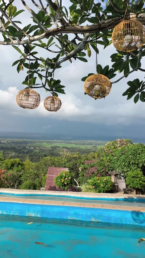 Tropical Infinity Pool View with Hanging Rattan Lanterns at Luxury Resort Stock Footage 340464678