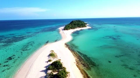 A tropical island paradise featuring a deep blue gradient ocean horizon. Видео 332830778