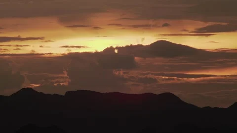 Tropical Island Silhouette Beneath Dramatic Sunset Sky Видео 337527067