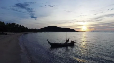 Tropical Island sunset with beach and boat in silhouette, with orange and blue Video stock 59776593