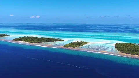 Tropical islands surrounded by turquoise ocean under clear sky Stock-Footage 341329474
