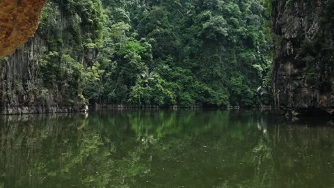 Tropical lagoon surrounded by limestone cliffs and lush jungle Stock-Footage 335668198