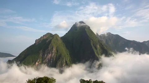 Tropical mountain peak above the clouds - Nong Khiaw, Laos Stock Footage 135381496
