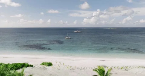 Tropical Ocean Beaches Featuring Large Luxury Yacht in Clear Blue Water Stock Footage 260653869