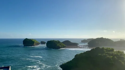 Tropical Ocean Cliffs and Small Islands at Pantai Kasap, Pacitan Stock Footage 335351332