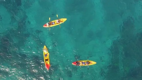 Tropical Ocean Kayakers Paddling Pull Out to WIde Shot, Top View -  Aerial Stock Footage 72153266