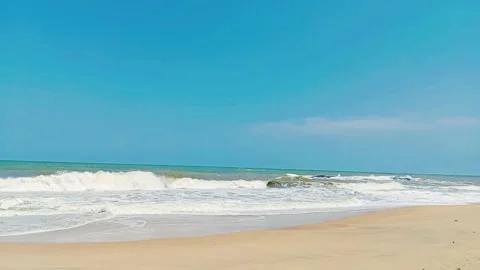 Tropical ocean waves crashing on sandy beach sunny day Stock Footage 346335909