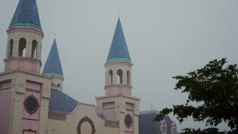 Tropical Rainstorm Over Castle Style Building With Trees Blowing in Wind Stock Footage 344534957