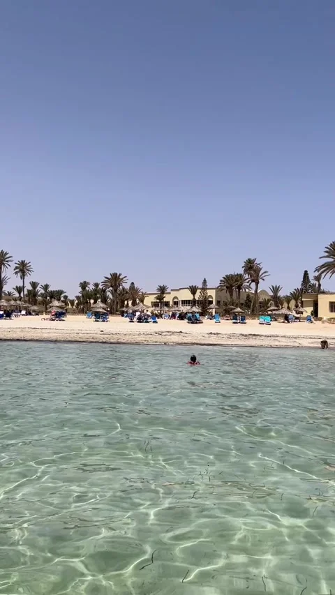 Tropical resort beach view from clear turquoise sea water Djerba HD vertical Stock-Footage 342078462