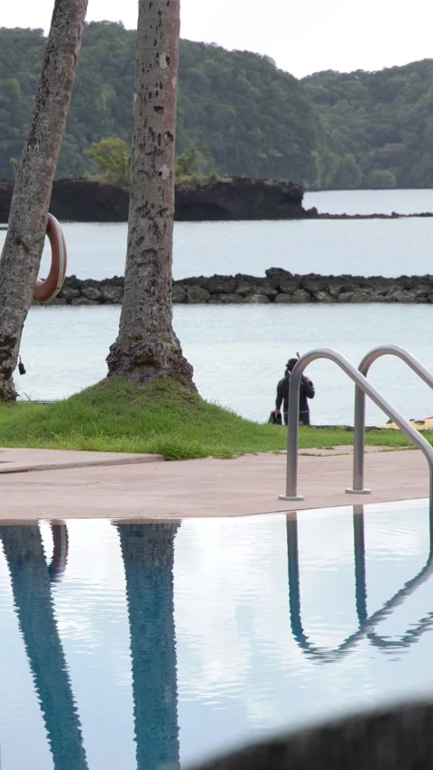 Tropical Resort Infinity Pool Overlooking Ocean and Islands in Palau Stock Footage 329345920