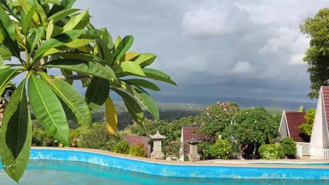 Tropical Resort Pool Overlooking Lush Valley and Mountains Stock Footage 340465449