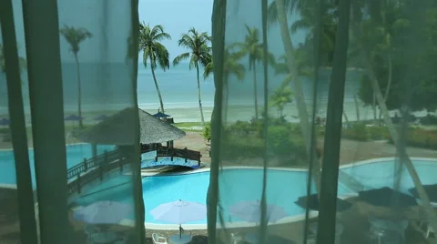 Tropical resort pool seen through room's window Stock Footage 60259868