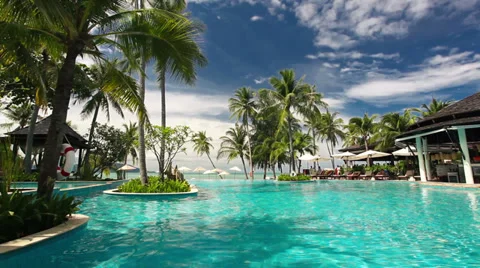 Tropical resort with swimming pool and ocean view Stock Footage