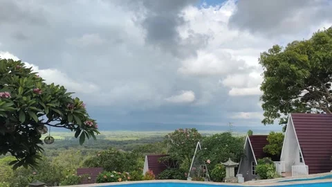 Tropical Resort View with Pool and Dramatic Sky Stock Footage 340465551