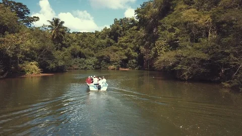 Tropical river with boat Stock Footage 100762913