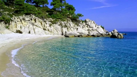 Tropical sandy beach with large rocks and blue sea Stock Footage 91070430