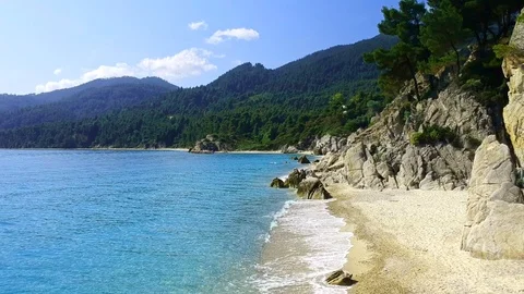 Tropical sandy beach with large rocks and blue sea Stock Footage 91070531