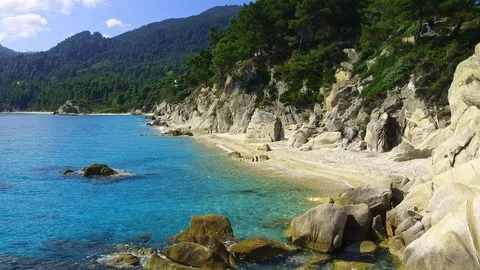 Tropical sandy beach with large rocks and blue sea Stock Footage 91070539