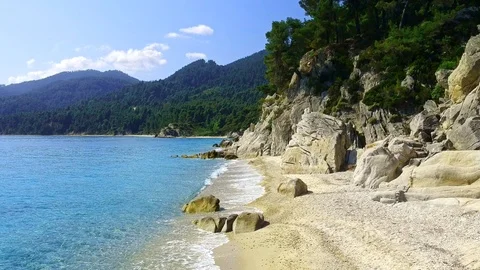 Tropical sandy beach with large rocks and blue sea Stock Footage 91070556
