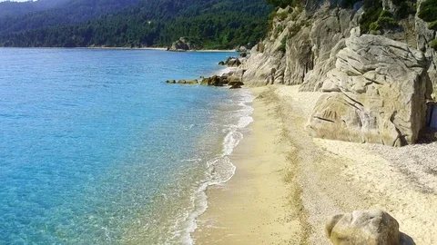 Tropical sandy beach with large rocks and blue sea Stock Footage 91070573