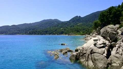 Tropical sandy beach with large rocks and blue sea Stock Footage 91070736