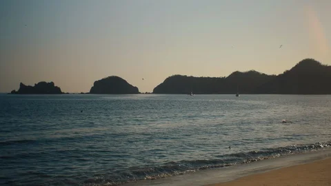 Tropical sandy beach with small islands in the distance Stock Footage 119124149