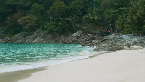 Tropical sandy beach with turuoise waters, palm trees and dense green foliage Stock Footage 278976305