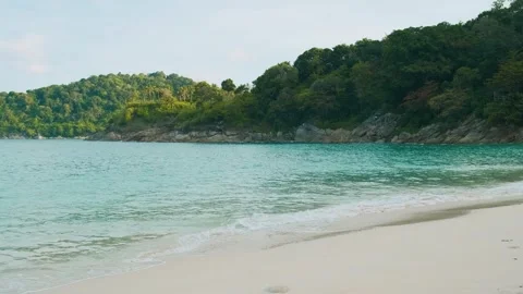 Tropical sandy beach with turuoise waters, palm trees and dense green foliage Stock Footage 280037182