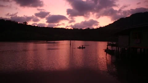 Tropical sea bay backlit by the declining sun with purple sunset sky. Stock Footage 277872498