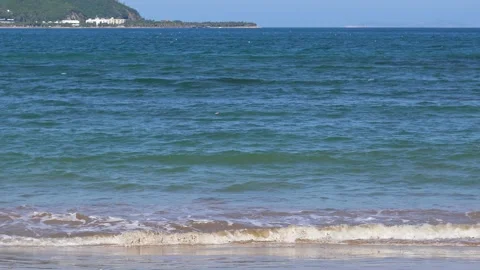 Tropical Sea Waves Rolling on Sandy Beach, Shoreline Under Sunny Blue Sky 動画素材 336664156