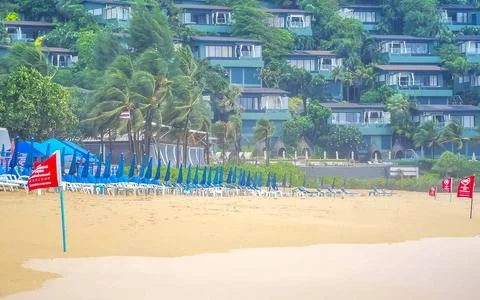 Tropical storm red warning flag turquoise waves Kata Noi Beach Thailand Stock Photos