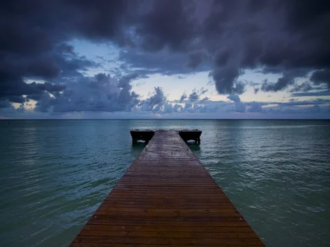 Tropical sunrise over wooden jetty pier on caribbean sea, Punta Cana beach Stock Footage