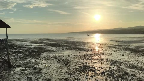 Tropical Sunset Over Low Tide Beach with Silhouette Gazebo Stock Footage 340464728