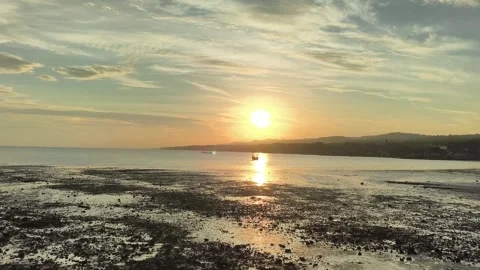 Tropical Sunset over Low Tide Beach with Traditional Fishing Boat Stock-Footage 340464936